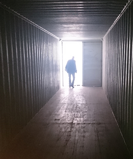 Person standing inside a container